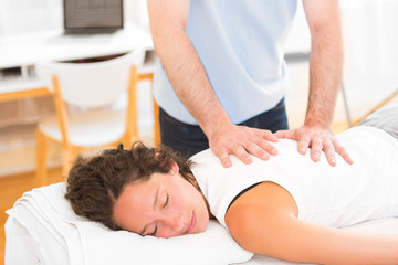 Young attarctive woman being manipulated by physiotherapist