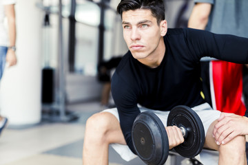 Fototapeta na wymiar Young man training in a gym