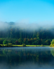 Morning fog over the river in sunshine