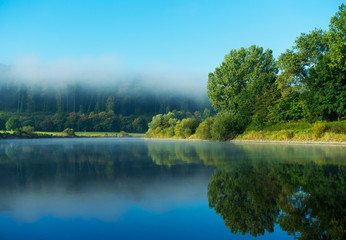 Morning fog over the river in sunshine