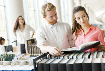 Two students reading and studying in library