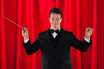Orchestra Conductor Holding Baton