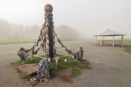 Ceremonial pole with ribbons on the road
