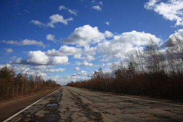 Obraz na płótnie Canvas Autumn road and sky with clouds