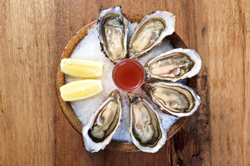 Oyster on round wooden bowl