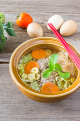 instant noodle in a bowl on a wooden background.