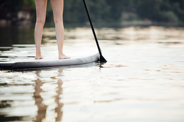 clouse-up of a woman legs on paddleboard