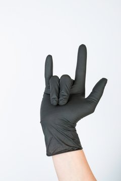 Hand in black medical glove. Stock image macro.