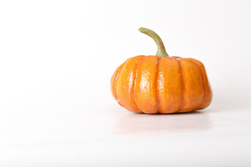 Orange halloween pumpkin gift on white background