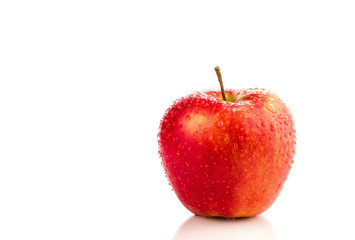 Red apple with water drops.