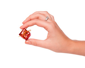 hand with Christmas toys on a white background