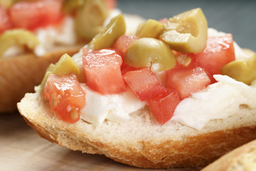 crostini with tomato, mozzarella and olives