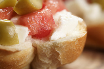 crostini with tomato, mozzarella and olives