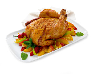 Whole roasted chicken with vegetables and herbs isolated on white