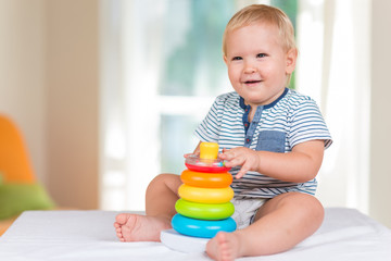 Cute little child is playing with toys