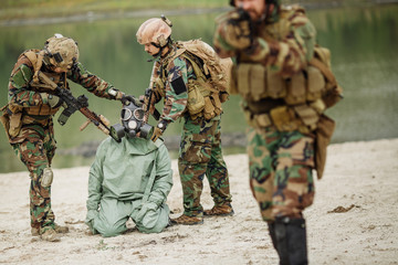 Army rangers captured a scientist with protective mask and prote