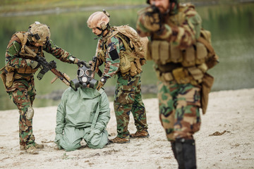 Fototapeta premium Army rangers captured a scientist with protective mask and prote