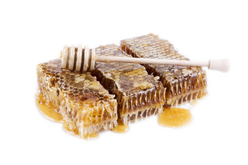 honeycomb with honey and honey stick on white background