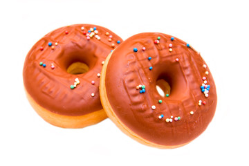 Donuts with chocolate and colored sugar on white background