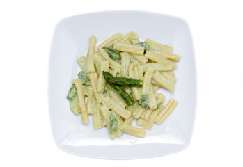 Pasta with cream of asparagus on a white background top view