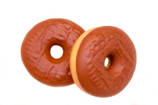 Donuts with chocolate on white background seen from above
