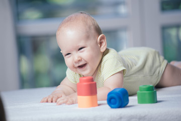 baby boy playing with colorful toy blocks
