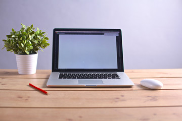 Fototapeta premium Laptop stands on a wooden table