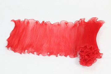 Pressing a red chiffon on a white background.