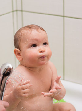 cute one year old boy taking a bath