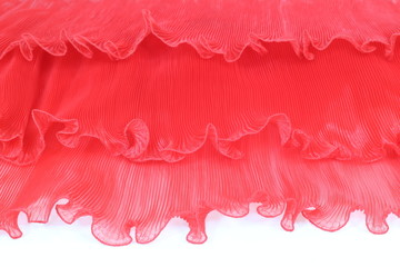 Pressing a red chiffon on a white background.