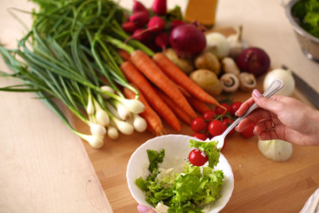 Young Woman Cooking in the kitchen. Healthy Food