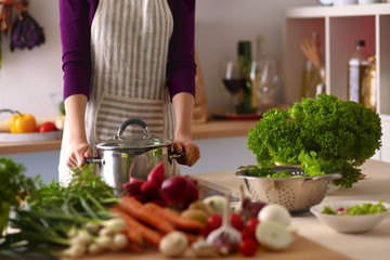 Young Woman Cooking in the kitchen. Healthy Food