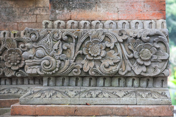 Brick wall with stone carving in Bali,Indonesia.
