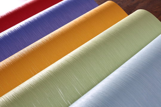 rolls of colored corrugated paper closeup on background 