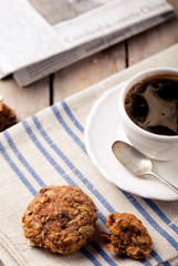 Cup of coffee with cookies and morning newspaper