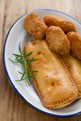 typical portuguese appetizers on white dish on brown wooden background