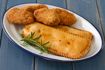 typical portuguese appetizers on white dish on blue wooden background