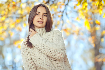 Beautiful woman in a sweater in park 