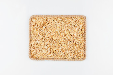 Frame made of the rope with oats grain on a white background