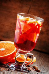 Hot mulled wine with orange and lemon, selective focus