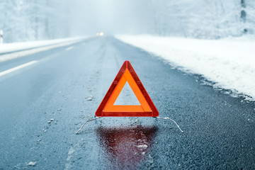 Winter Driving  - Warning triangle on a winter road