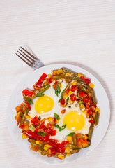 fried eggs with mixed vegetables on plate