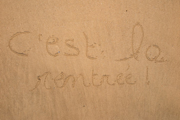 Back to school in french on the sand as a background