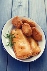typical portuguese appetizers on white dish on blue background