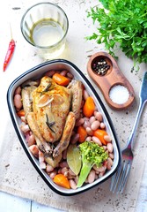 roast pigeon with Cassoulet beans, onions, bacon, carrots, broccoli, rosemary and parsley
