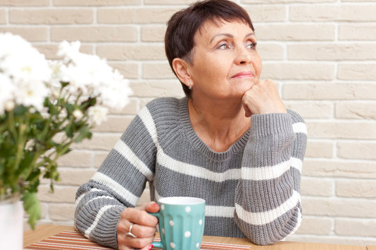 50 Years Old Attractive Woman With A Cup Of Tea At Home