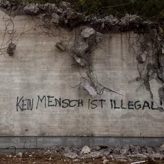 Poster Graffiti political statement on destroyed building in Germany