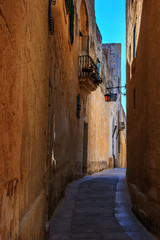 Fototapeta na wymiar Antique narrow maltese street in Mdina