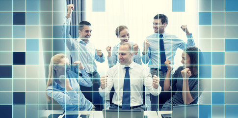 business people celebrating victory in office