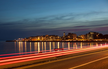 City on the bank of the ocean at night